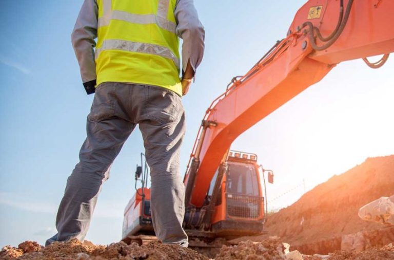 Construction engineer wear personal protective equipment stand a