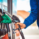 Male hand holding fuel pump nozzle, Diesel Fuel, Car,